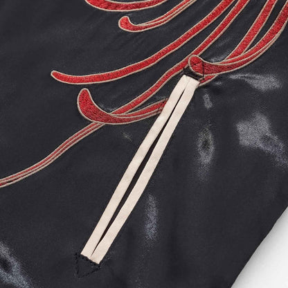 Double-welt pocket in beige; chrysanthemum tendril flowing across the front.