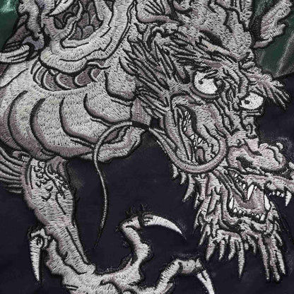 Dragon head and claw embroidery close-up with sharp fangs and whiskers.