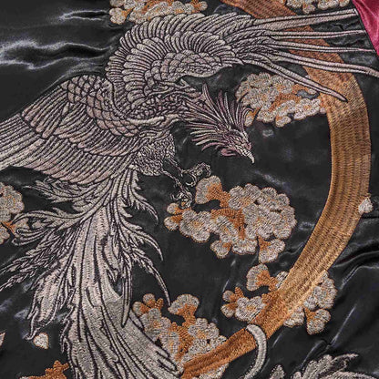 Phoenix embroidery close-up with flowing tail feathers and blossoms.