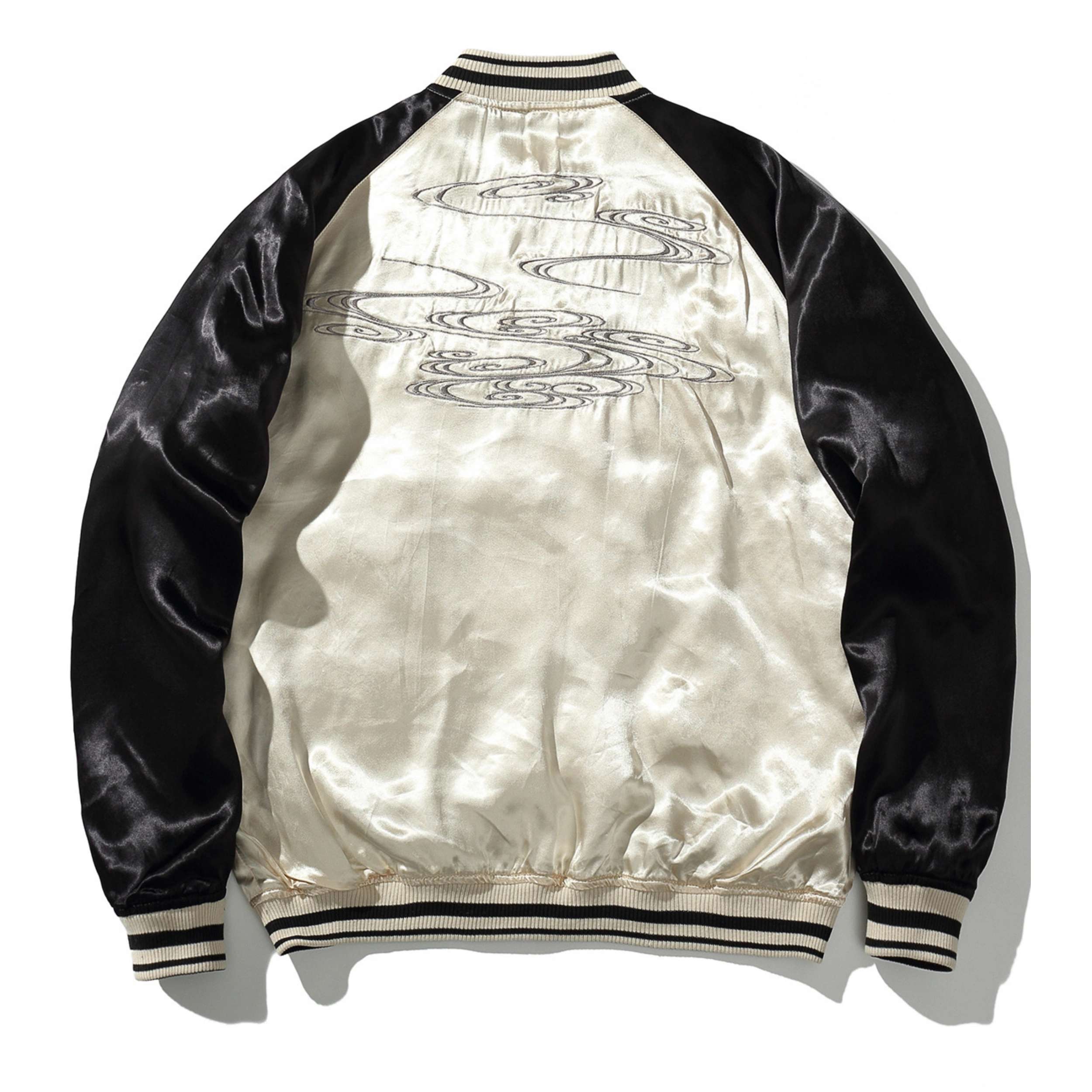 Ivory side back view — flowing ripples motif stitched across the panel.