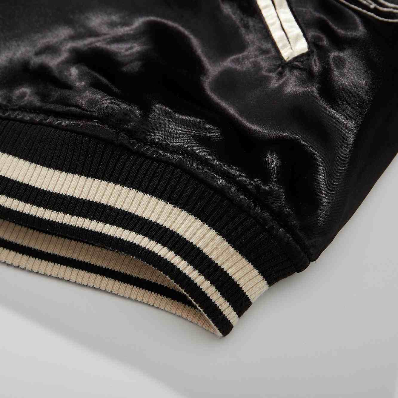 Hem detail — striped rib hem on black side.