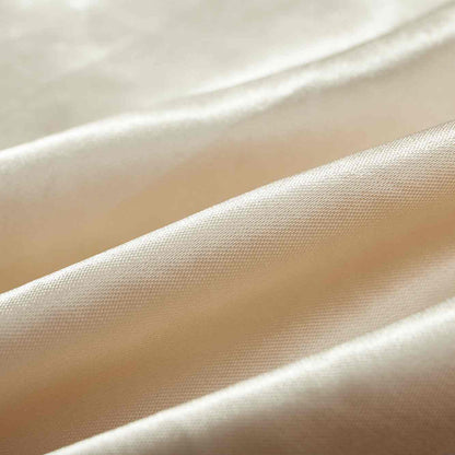 Fabric detail — smooth ivory satin texture.