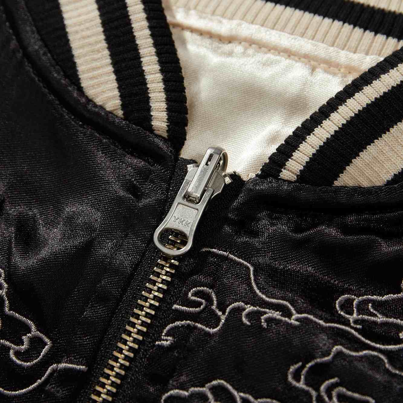 Hardware detail — close-up of YKK metal zipper slider.