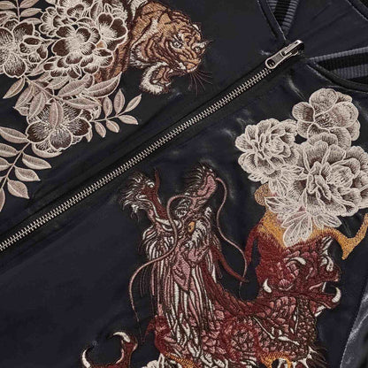 Chest detail — dragon embroidery and peony blooms by zipper.