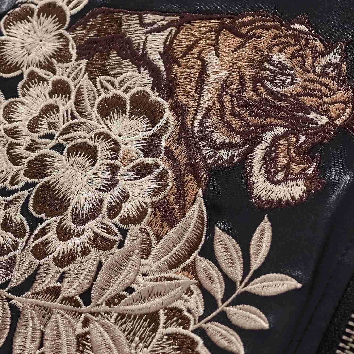 Chest detail — roaring tiger framed by layered peonies.