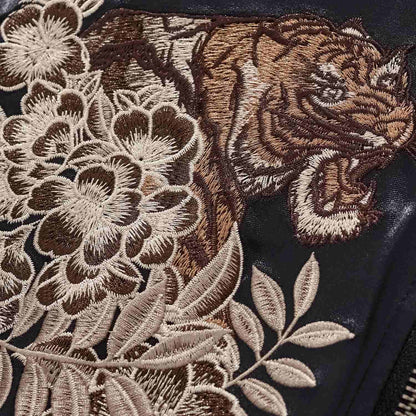 Chest detail — roaring tiger framed by layered peonies.