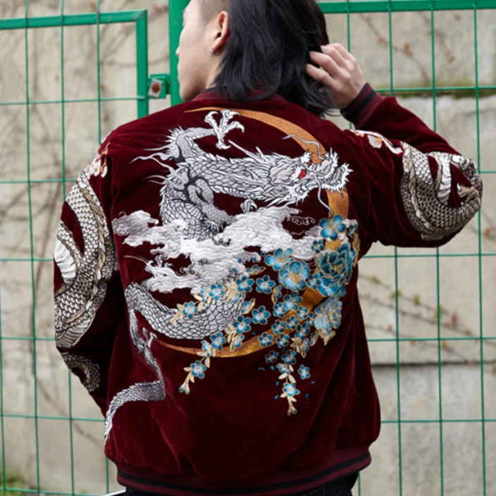Lifestyle — model wearing velvet sukajan (red), back view; white dragon with clouds, golden crescent and blue blossoms.