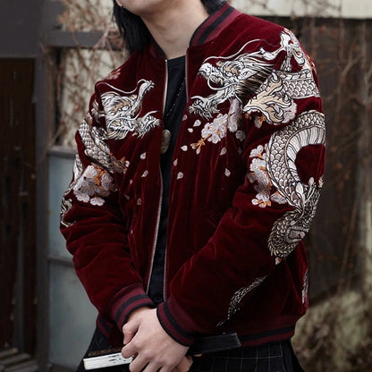 Lifestyle — model wearing velvet sukajan (red), front view; embroidered dragons on shoulders with scattered petals.