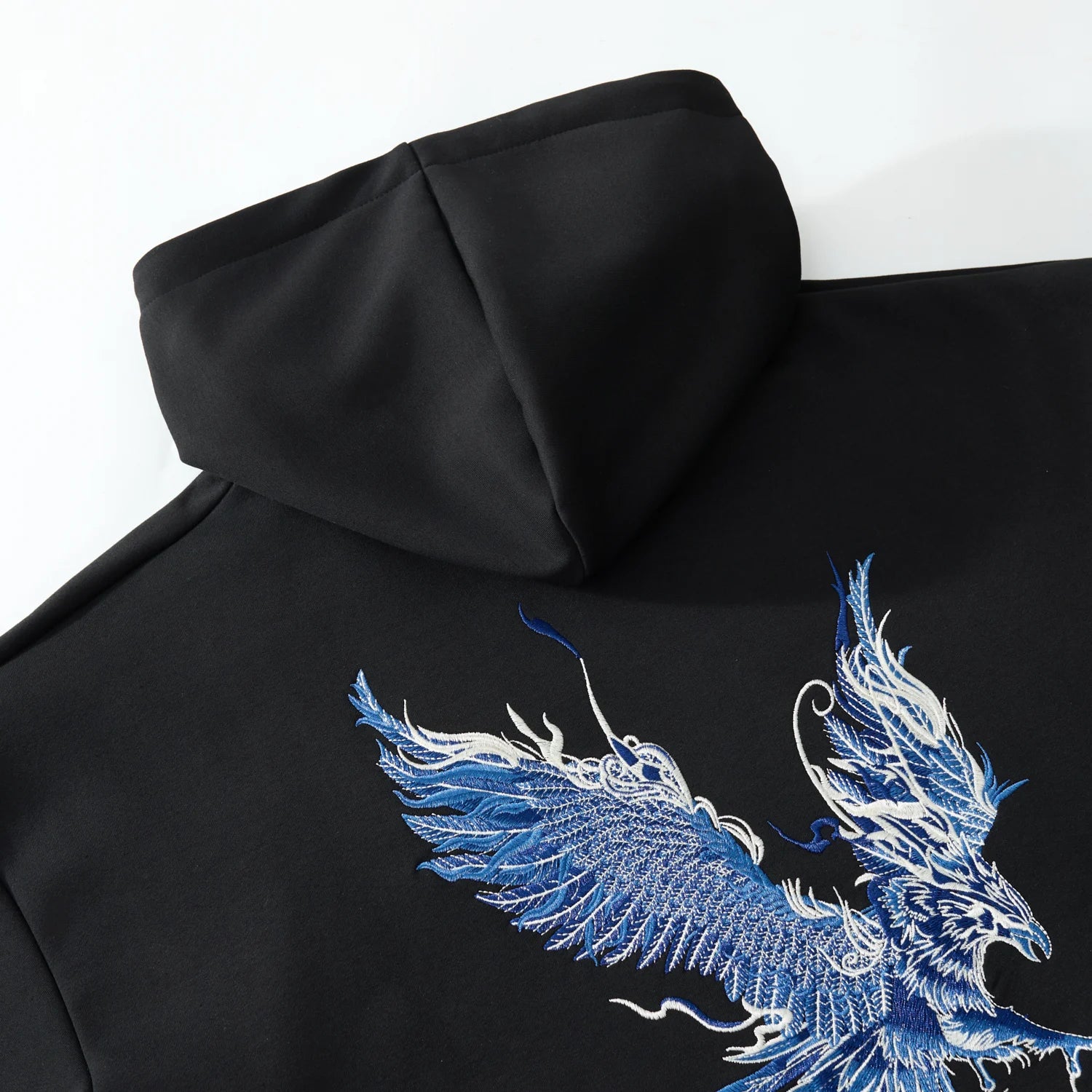 Hood and back detail of the black hoodie showing the phoenix wing