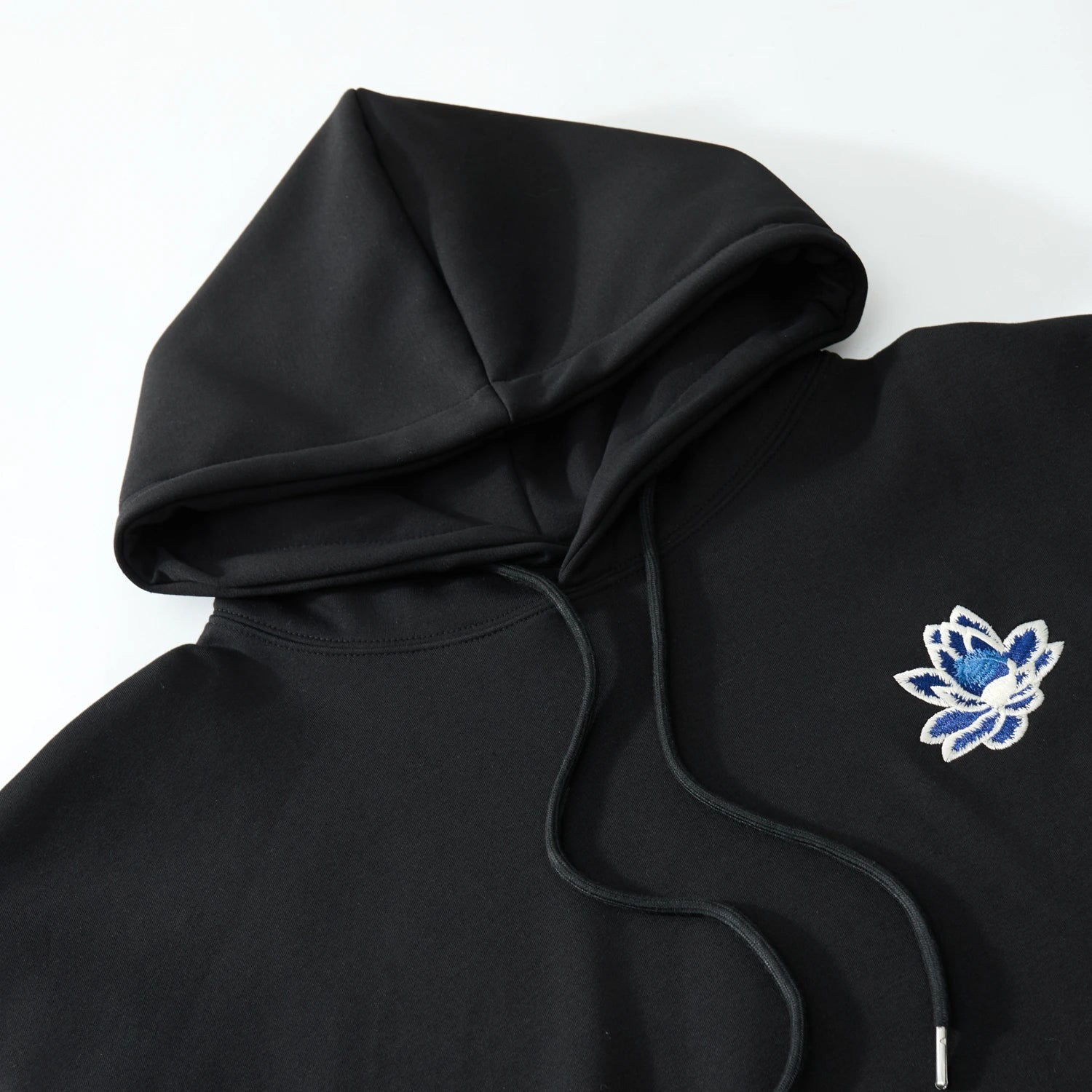 Hood and chest lotus detail on the black hoodie