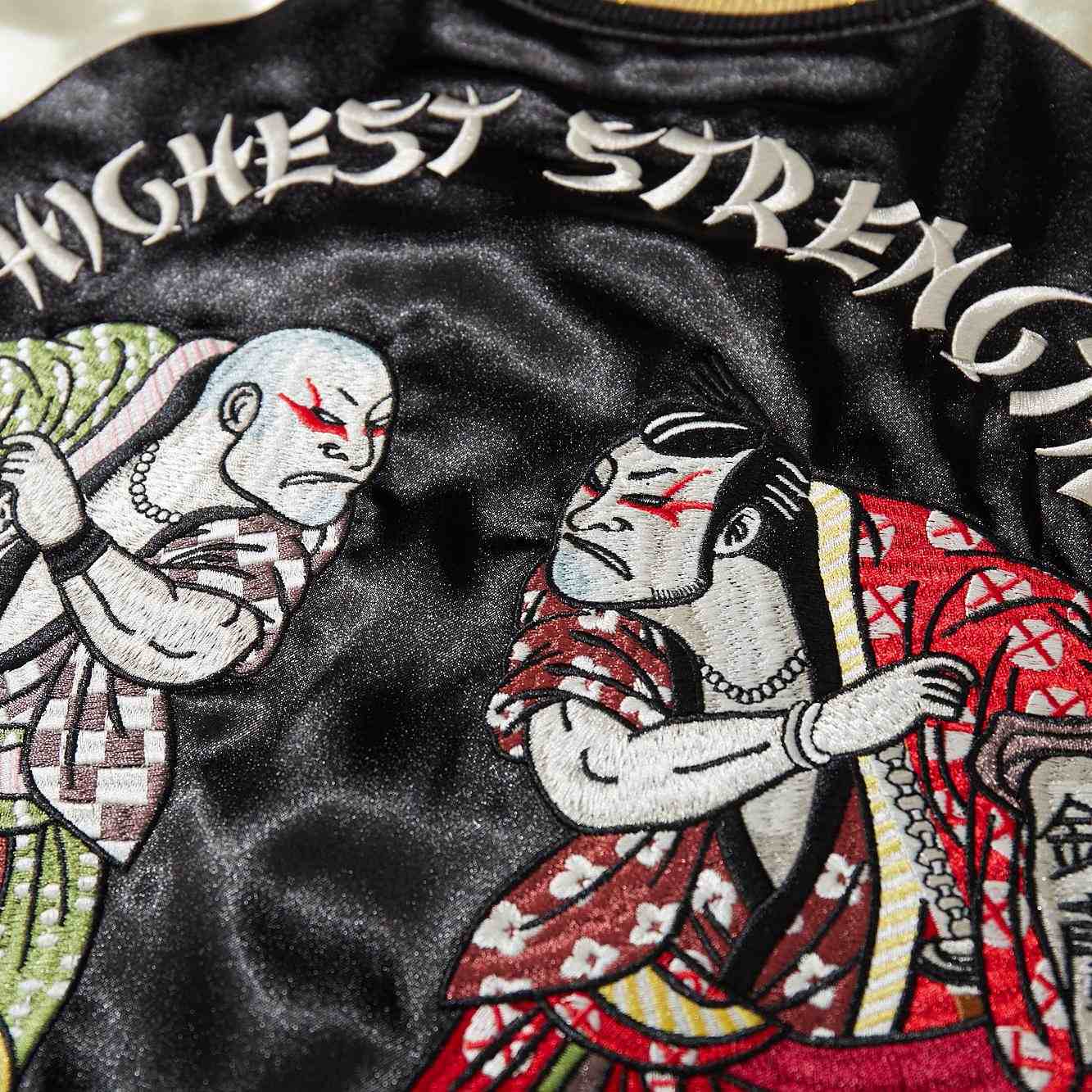 Macro embroidery of red-robed fighter and “Highest Strength” text on Crows Suzuran vs Housen rivalry sukajan jacket.