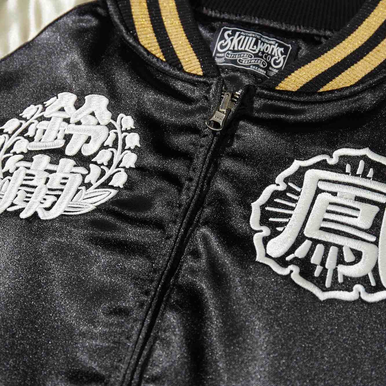 Detail of ribbed collar and twin white crest embroidery on front of Crows Suzuran vs Housen sukajan bomber jacket.