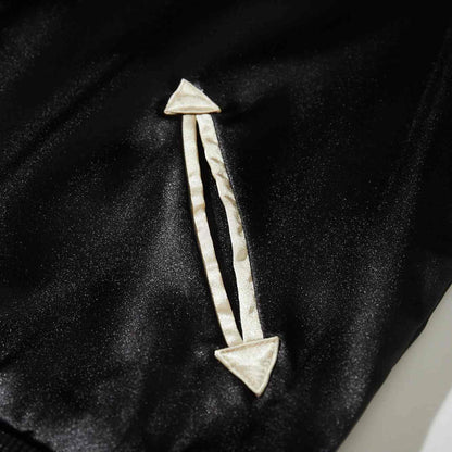 Close-up of arrow-shaped welt pocket with beige trim on black satin Crows Suzuran vs Housen sukajan jacket.