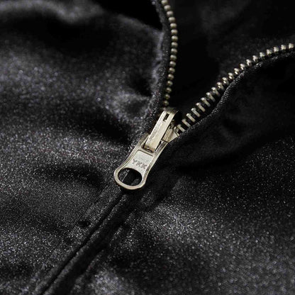 Macro detail of sturdy YKK metal zipper on black satin Crows Suzuran vs Housen sukajan jacket.
