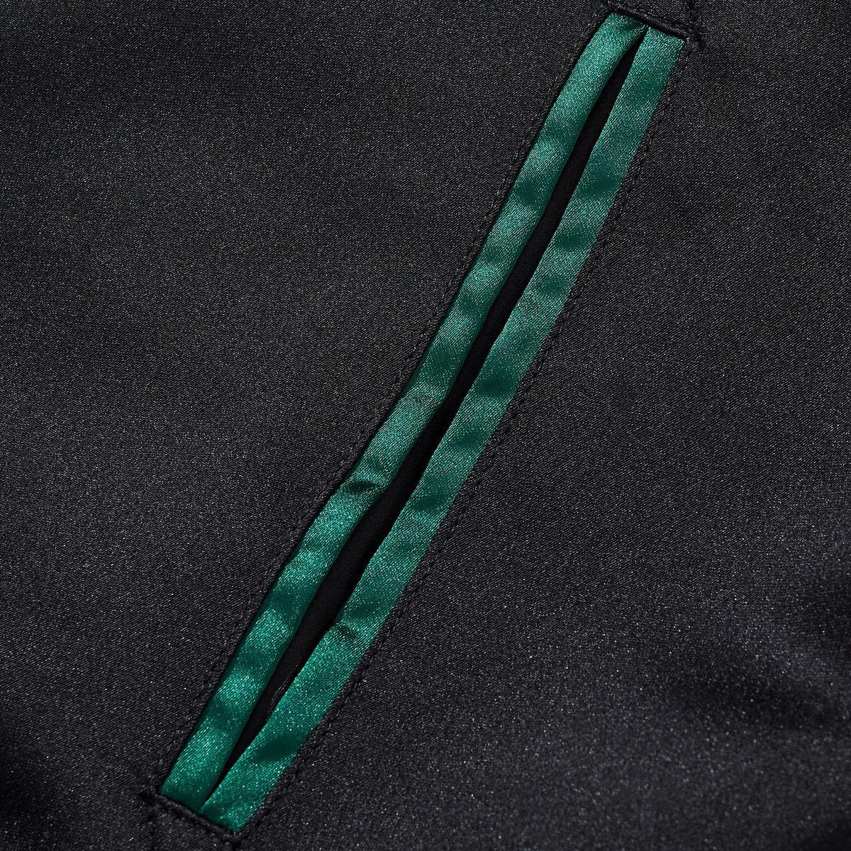 Slanted welt pocket trimmed with emerald-green satin piping