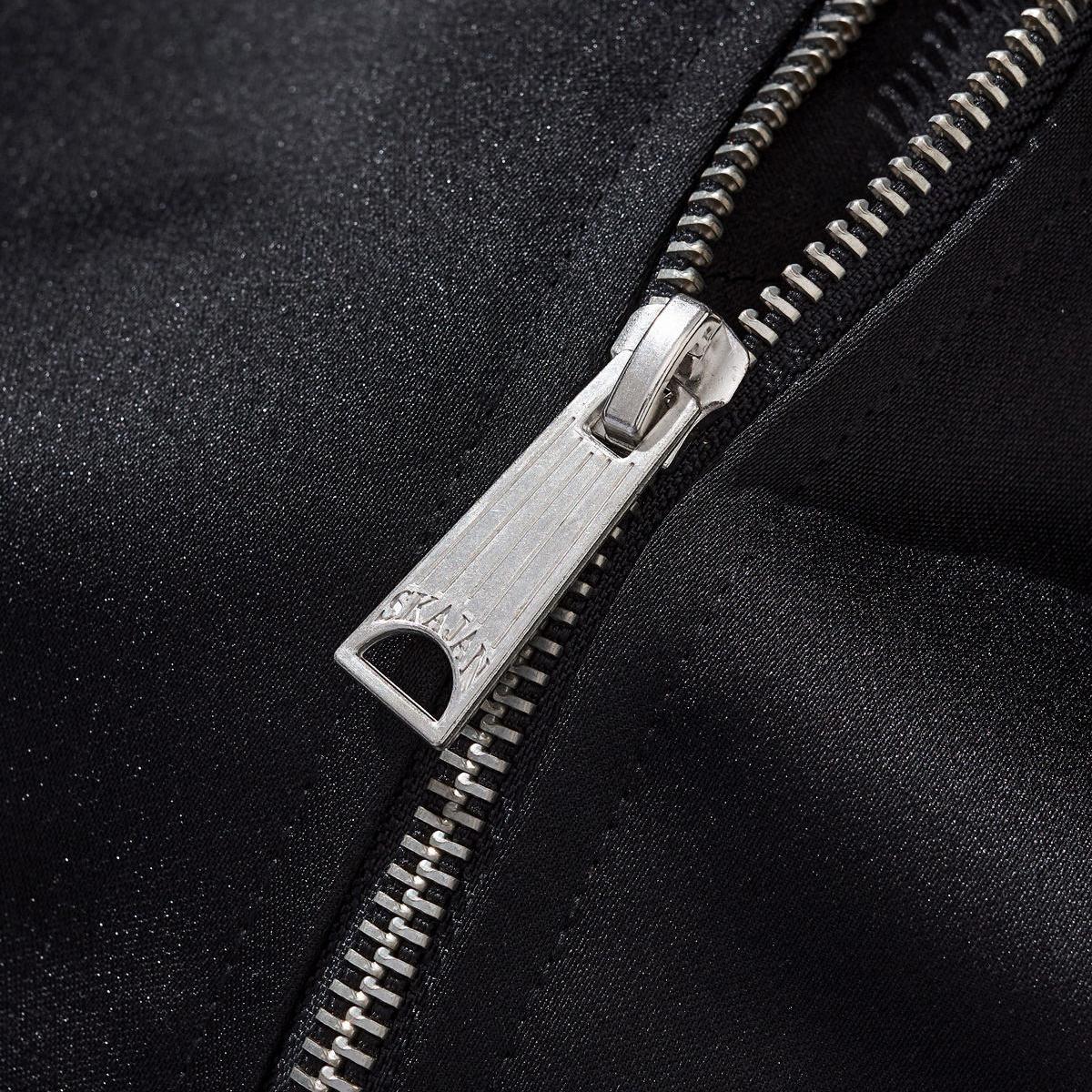 Close-up of the metal zipper puller with engraved branding