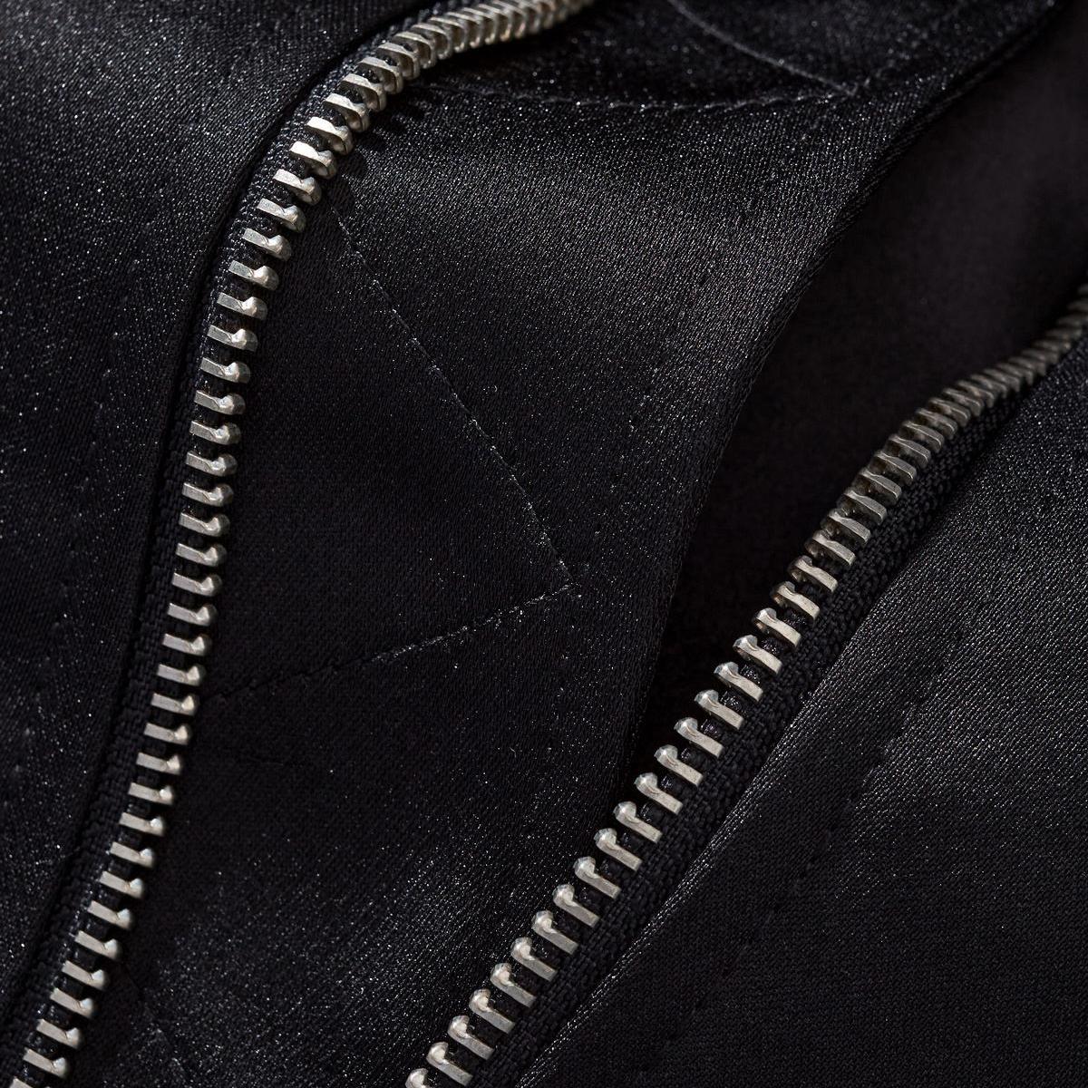 Macro shot of sturdy metal zipper teeth and reinforced hem stitching