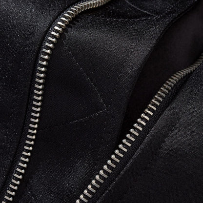 Macro shot of sturdy metal zipper teeth and reinforced hem stitching