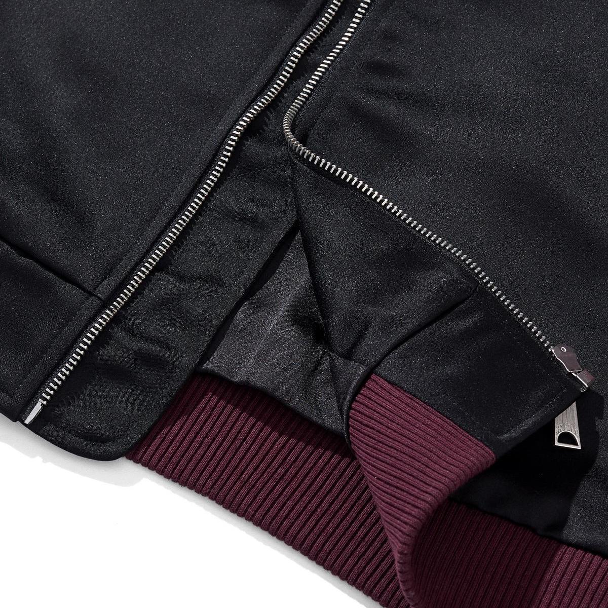 Hem and zipper construction detail with ribbed waistband