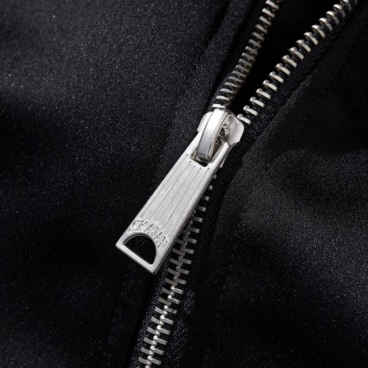 Metal zipper pull close-up with crisp teeth