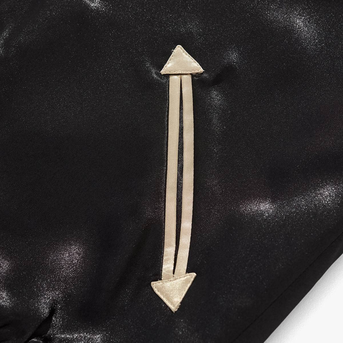 Close-up of beige arrow welt pocket on black body of Dragon Ball Goku & Shenron sukajan jacket.