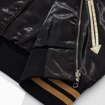 Close-up of ribbed striped hem, zipper and arrow pocket on Dragon Ball Goku & Shenron sukajan jacket.