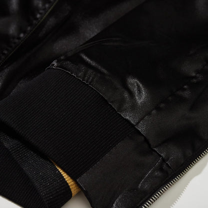 Close-up of gold striped ribbed hem on Dragon Ball Rider embroidered sukajan jacket.