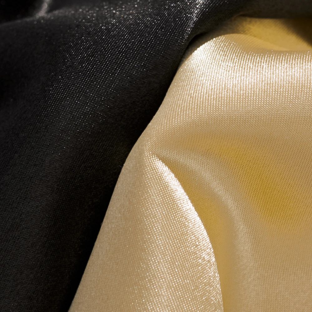 Macro detail of black and beige satin fabric showing smooth, glossy texture on Dragon Balls sukajan jacket.