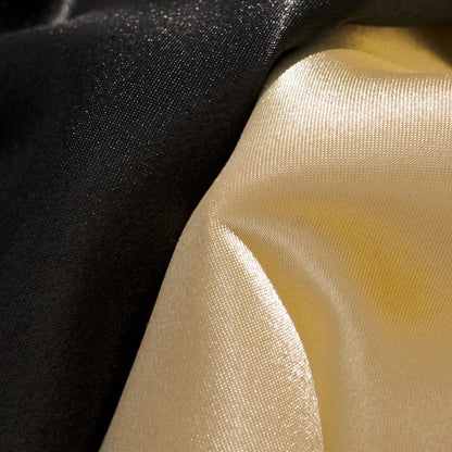 Macro detail of black and beige satin fabric showing smooth, glossy texture on Dragon Balls sukajan jacket.