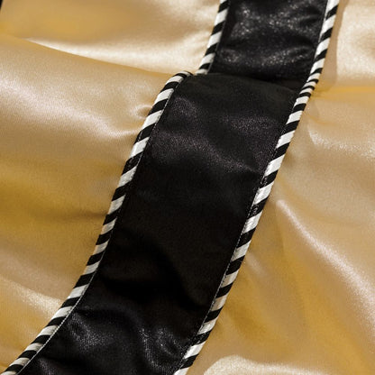 Close-up of twisted black and white piping along satin sleeve of Dragon Balls anime sukajan jacket.