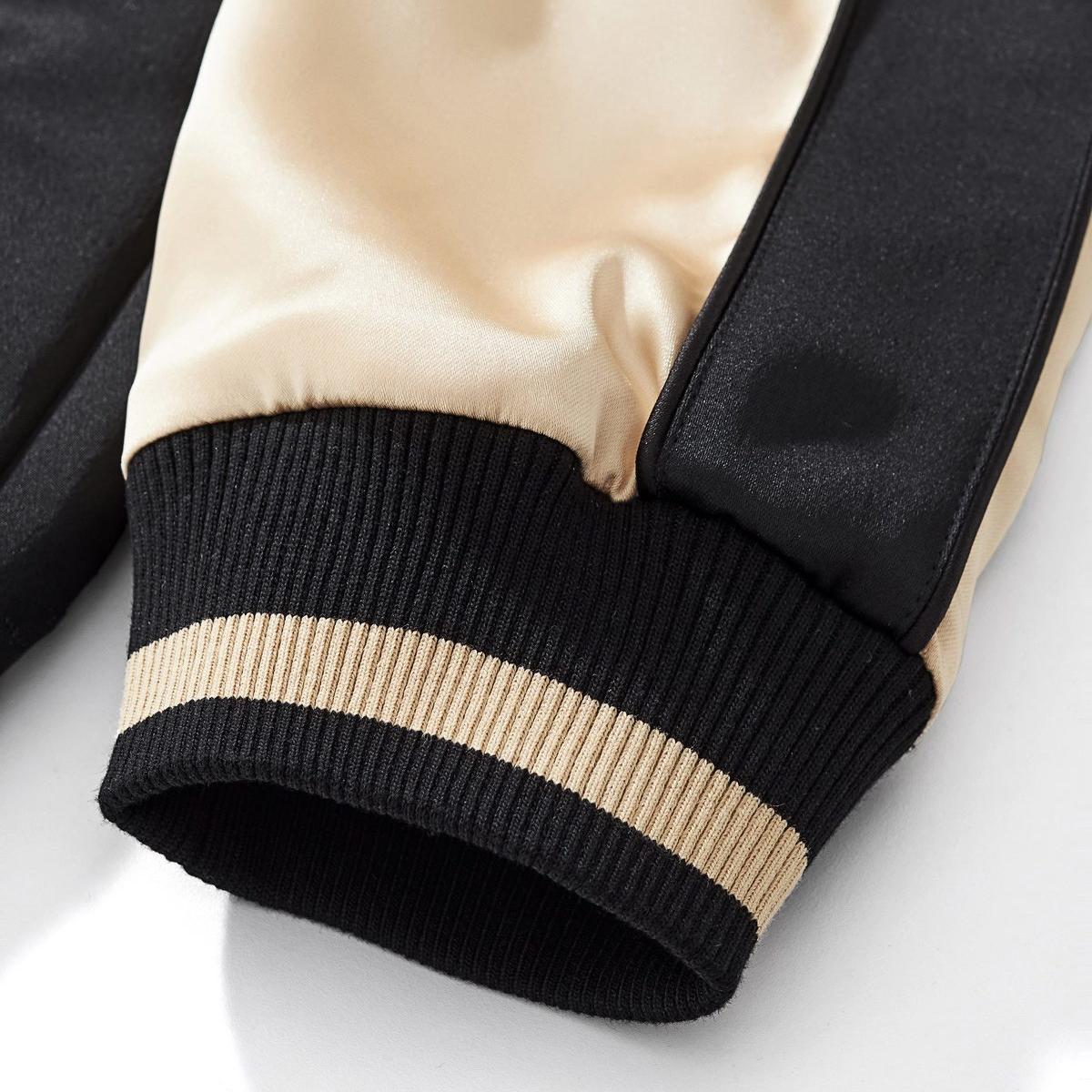 Elastic ribbed cuff with contrast stripe for a snug, wind-resistant seal.