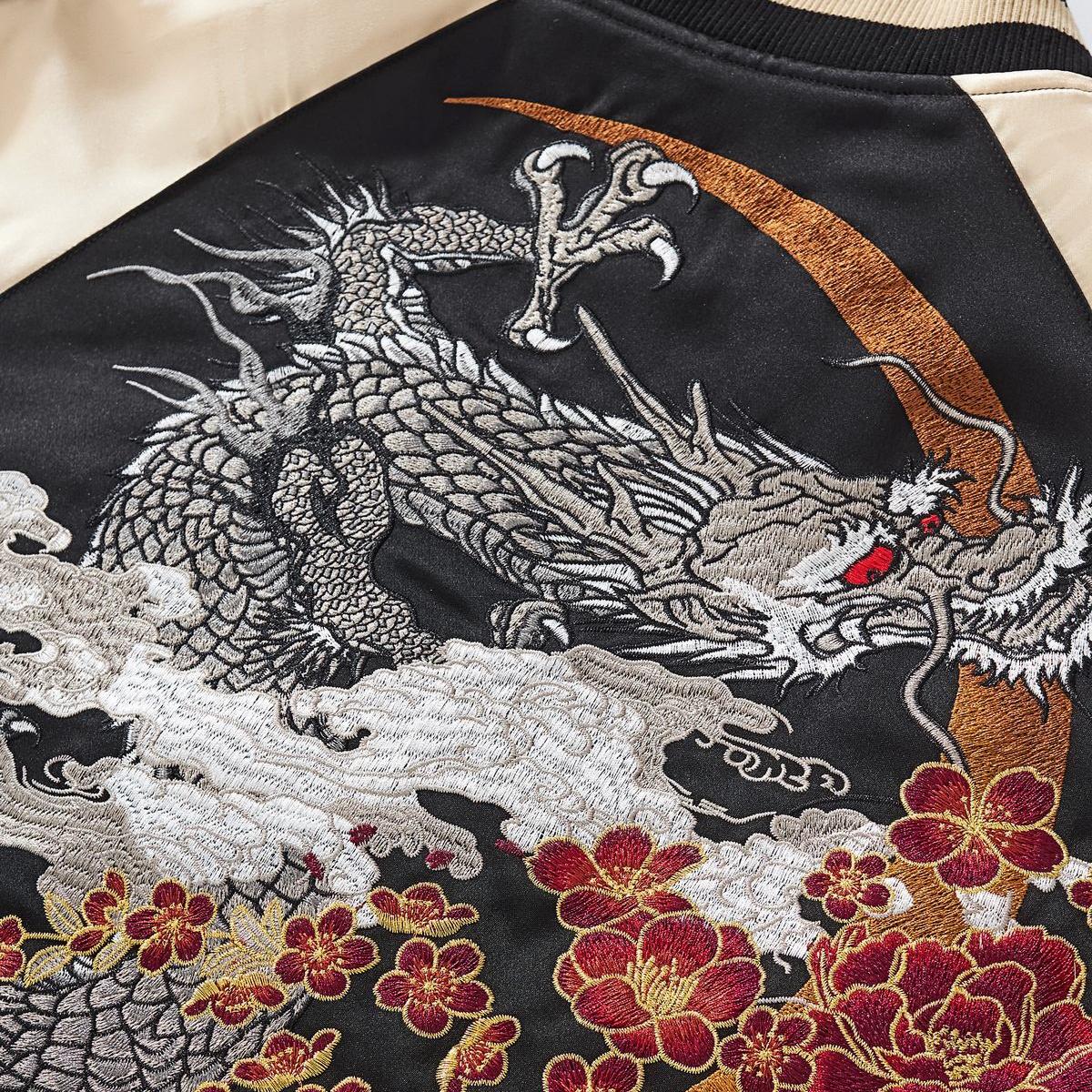 Dense metallic-thread dragon embroidery over a crescent motif, rich texture and crisp edges