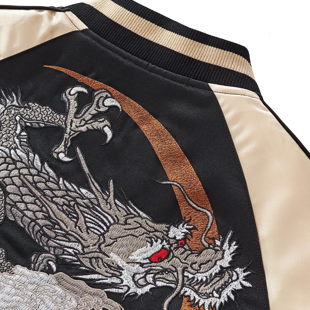 Shoulder detail — moon ring arc with fierce dragon head; smooth satin sleeve panel.