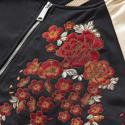 Close-up of peony embroidery — layered satin threads with crisp metallic-edged outlines.
