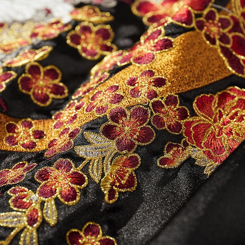 Embroidered peony cluster with decorative golden arc; dense satin stitching.
