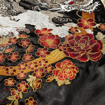 Peony blooms beneath a crescent, layered over dragon and cloud embroidery.