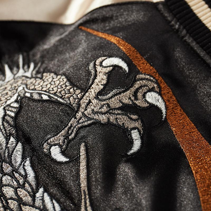 Embroidered dragon claw over crescent motif, dense satin stitches and texture.