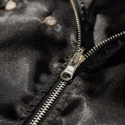 Close-up of durable YKK zipper pull and teeth on the souvenir jacket.