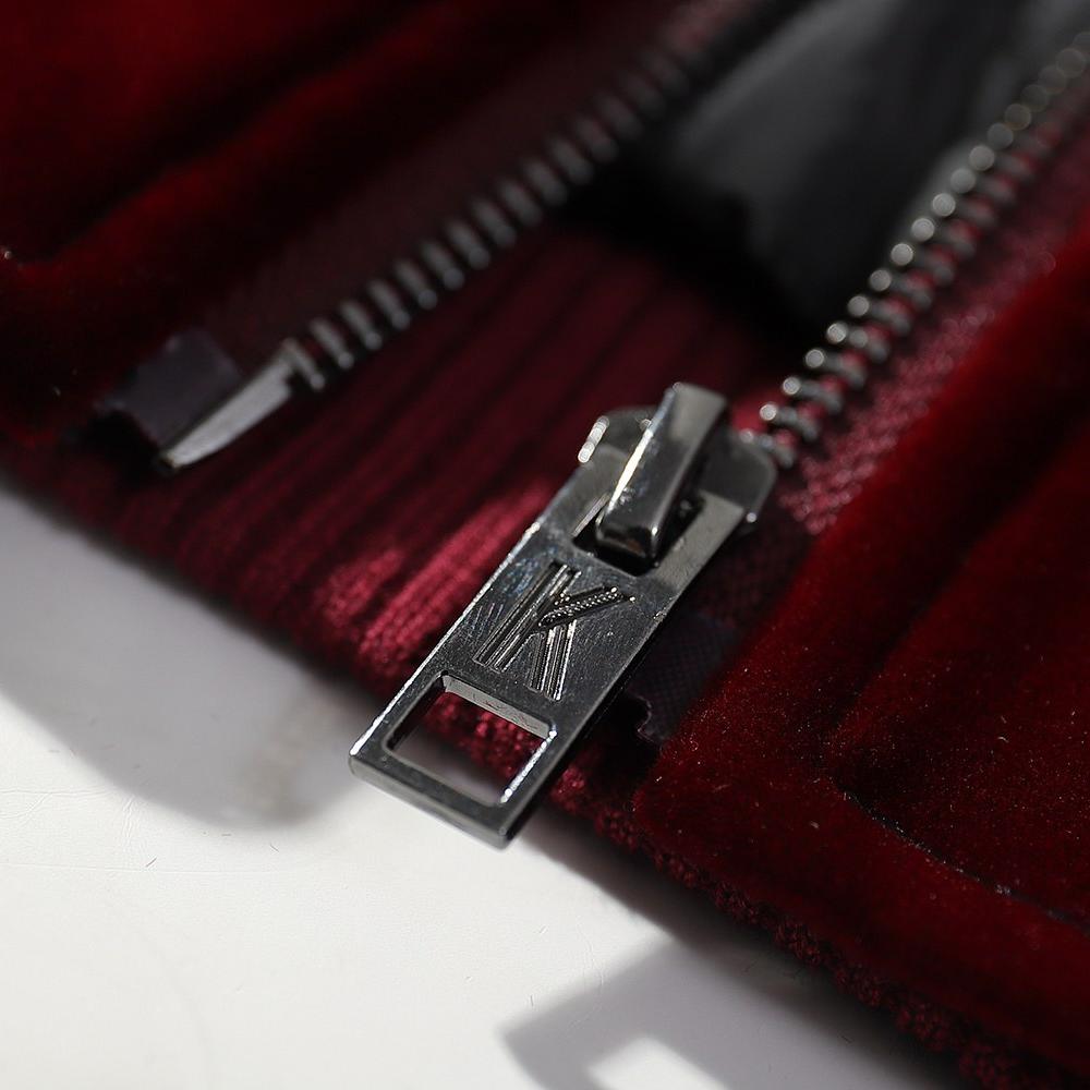 Metal zipper pull close-up on the velvet sukajan