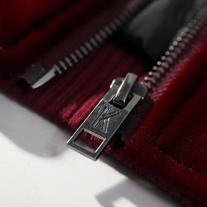 Metal zipper pull close-up on the velvet sukajan