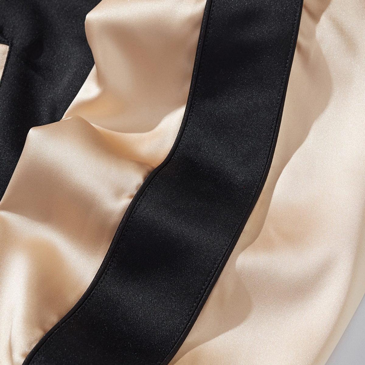 Smooth satin sleeve panel with neat topstitching