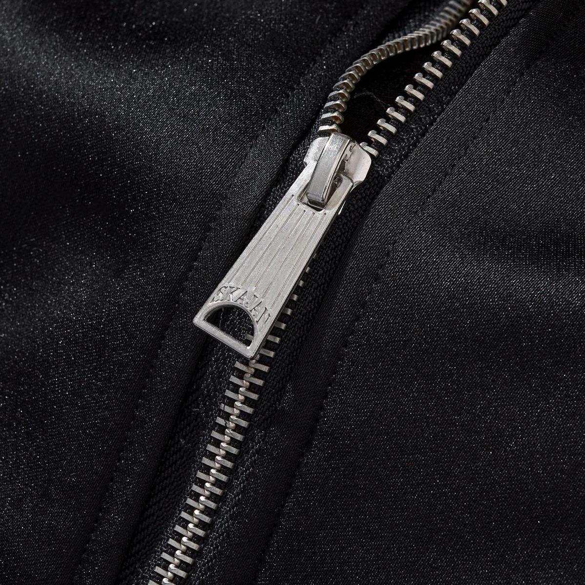Metal zipper pull close-up with fine teeth
