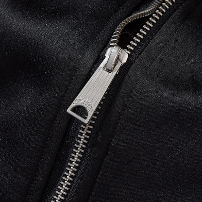 Metal zipper pull close-up with fine teeth