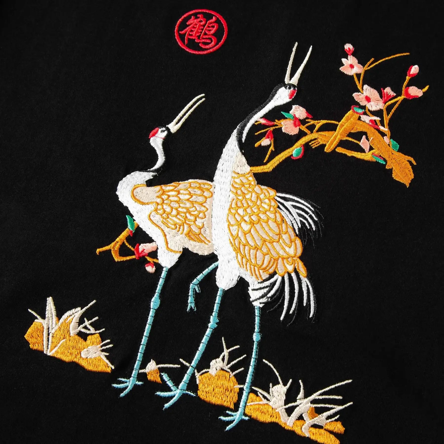 Close-up of cranes and sakura chest embroidery on the T-shirt