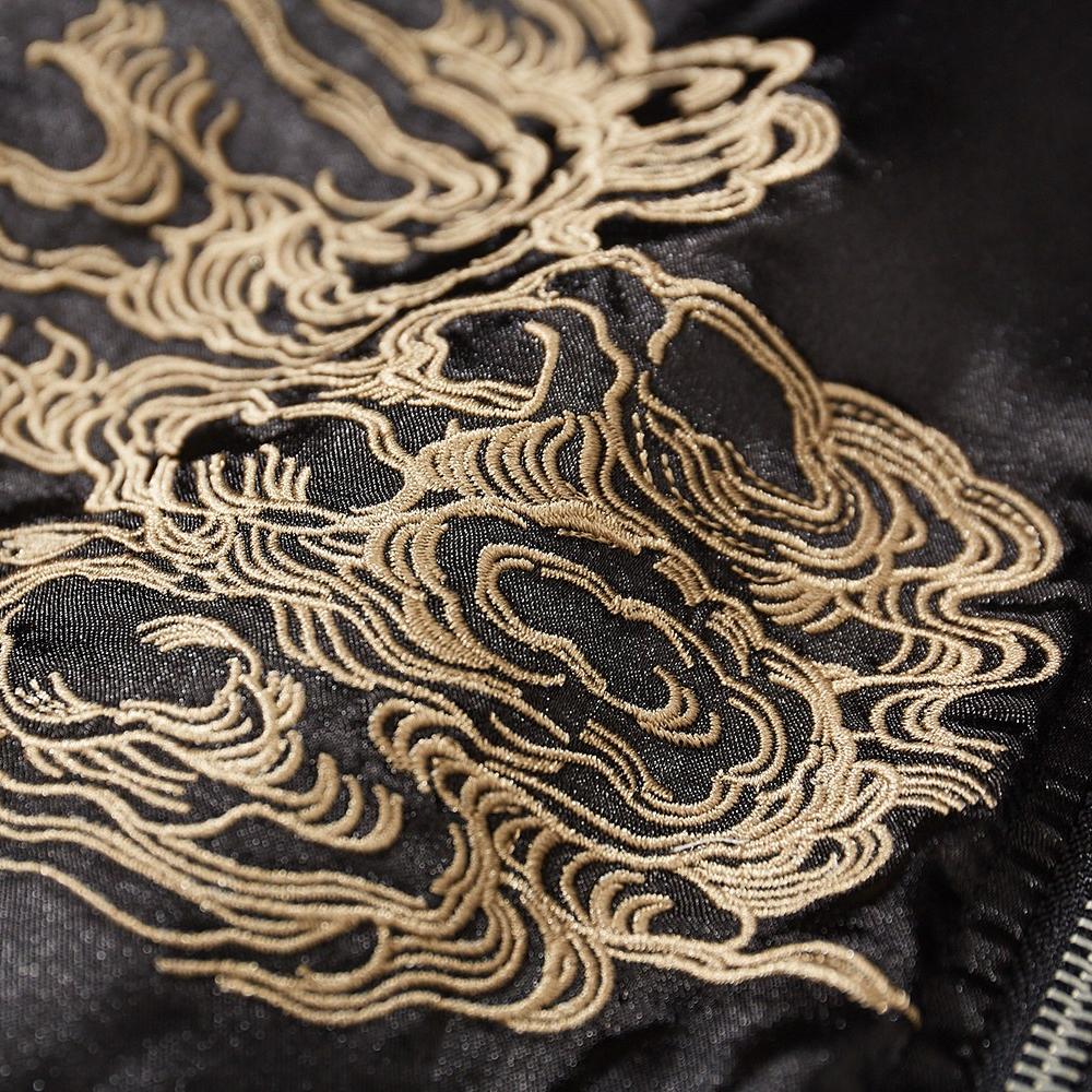 Close-up of swirling cloud embroidery on a black sukajan