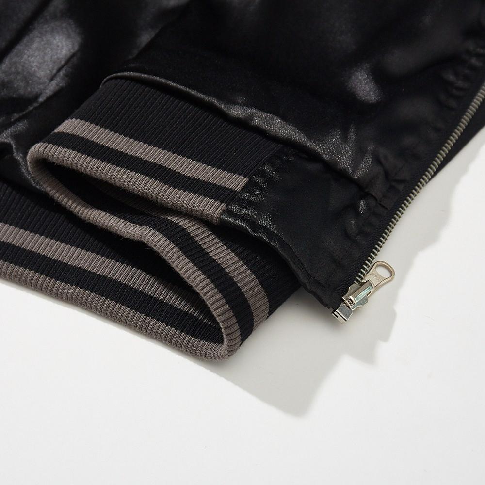 Close-up of striped ribbed hem with zipper end on a sukajan