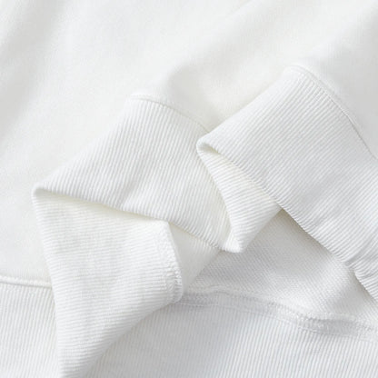 Detail of ribbed cuffs and hem on white Nine-Tailed Fox & Lotus sweatshirt.