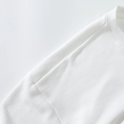 Close up of smooth shoulder construction and white fabric on Nine-Tailed Fox & Lotus sweatshirt.