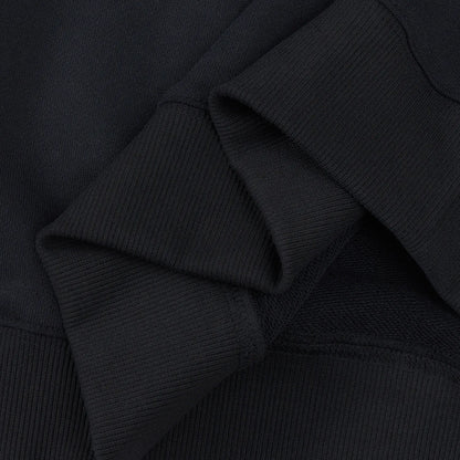 Inside view of ribbed cuff and stitching on black Nine-Tailed Fox & Lotus sweatshirt