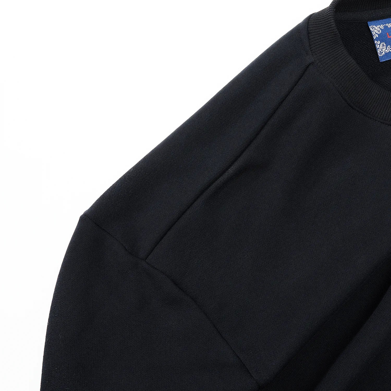 Shoulder and sleeve construction detail on black Nine-Tailed Fox & Lotus sweatshirt